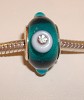 Verzilverde glasbedel Petrol met turquoise stip en strasssteentjes
